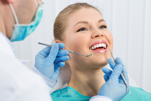woman getting teeth checked